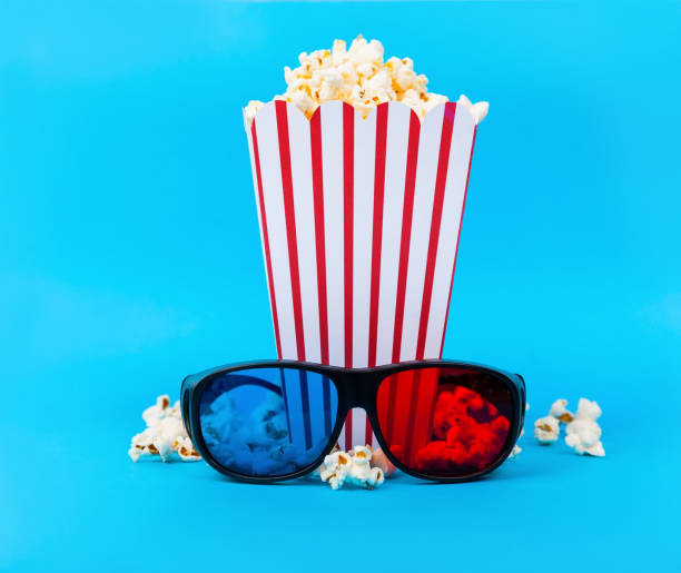 istock Popcorn and 3d glasses on blue background 973480948