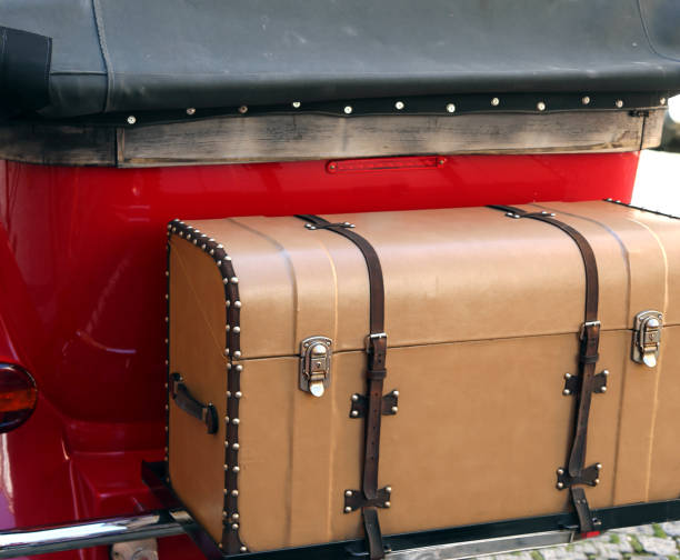 istock vintage car with luggage and an old trunk 973488134