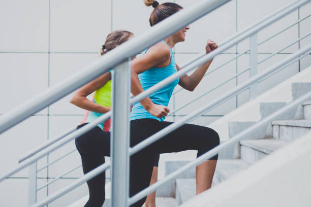 istock Friends running up urban staircase 973488420