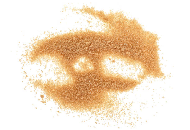 istock Brown sugar isolated on white background. Top view. 973489596