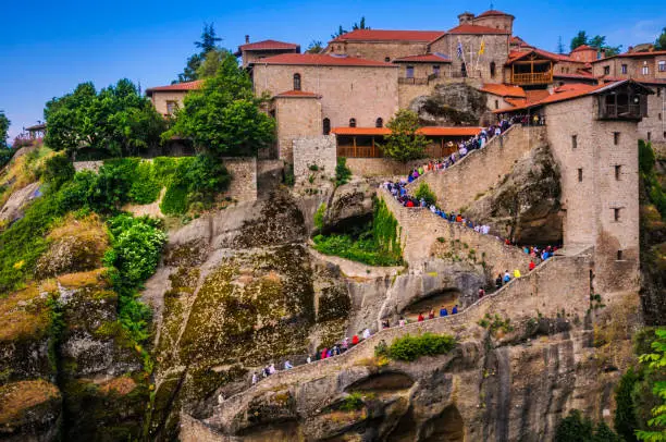 Scores of tourists and visitors climb the stairway leading to the Monastery of Great Meteoron in Greece