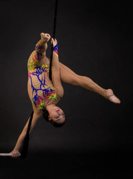 istock A young girl performs the acrobatic elements in the air trapeze. 973497650