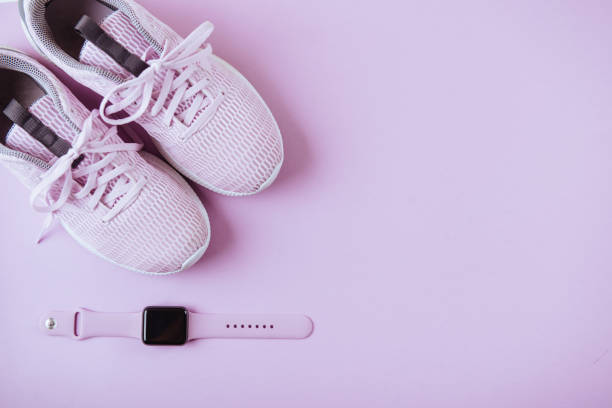 istock Violet sneakers, and watcheson pink background. 973498088