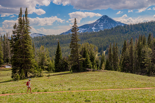 Hiking along the Beehive Basin Trail, with Big Sky Resort's iconic Lone Peak in the background.