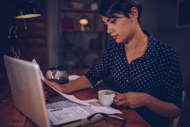 istock Woman reading a bank notification 973504494