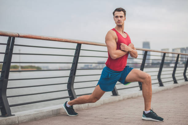 istock Male athlete stretching outdoors 973504902