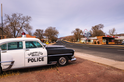 Seligman, Arizona, USA - January 2, 2018 : Vintage Chrysler New Yorker police car parks on historic route 66 in Arizona.