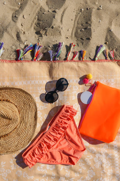 istock Swimsuit, sunglasses, hat on a beach 973512670