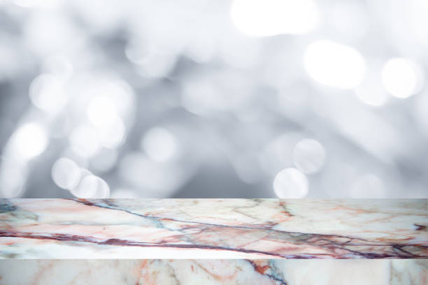 istock Empty marble table with backdrop white blurred nature background, Can be used for display your product 973512838