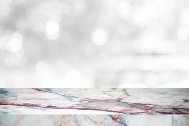 istock Empty marble table with backdrop white blurred nature background, Can be used for display your product 973515398
