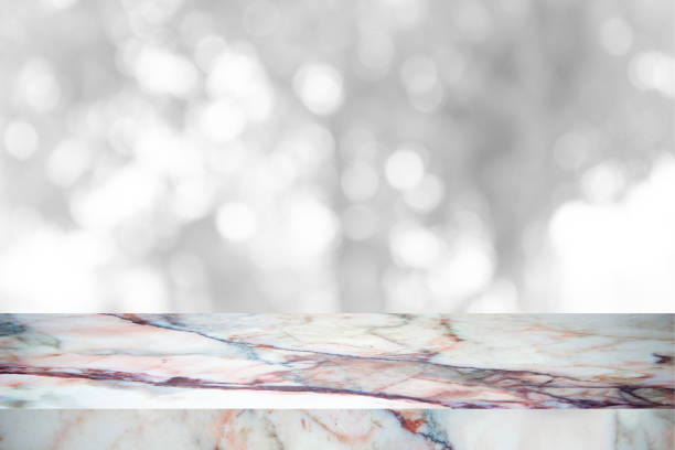 istock Empty marble table with backdrop white blurred nature background, Can be used for display your product 973515496