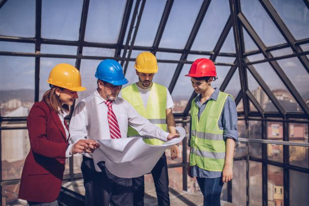 istock Architects and engeneers working together at construction site 973515840