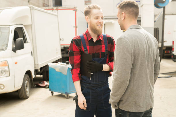 istock Car Mechanic Chatting With Customer 973519588