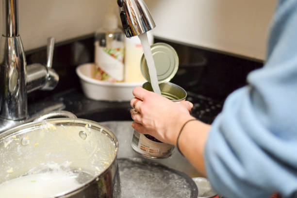 istock Closeup on woman's hands washing dirty dishes 973522370