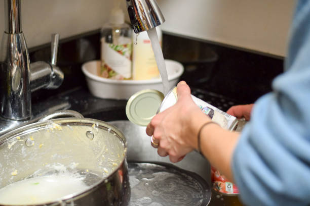istock Closeup on woman's hands washing dirty dishes 973522374
