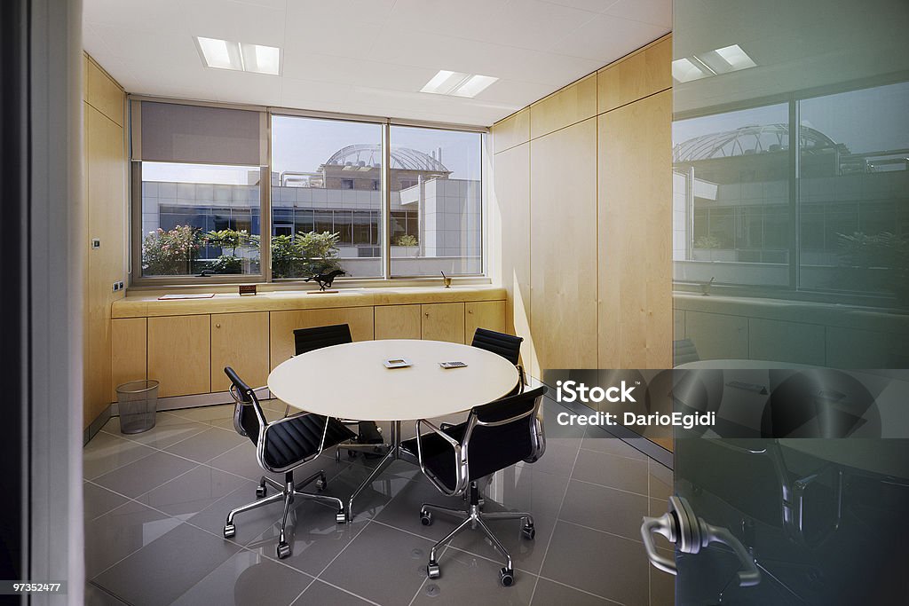 Modern meeting room with round table and four chairs Office of modern enviroment, office in a real-estate company located in Turin Piedmont Italy Small Office Stock Photo
