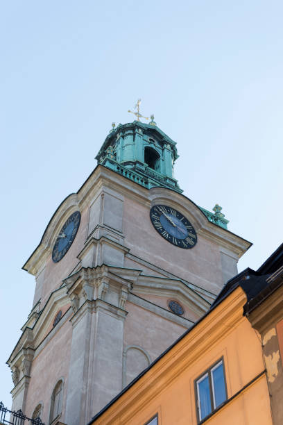 View of the tower of the church Sankt Nikolai kyrka (Church of St. Nicholas) on the streets of the old town in Stockholm, Sweden