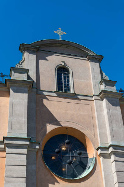 View of the tower of the church Sankt Nikolai kyrka (Church of St. Nicholas) on the streets of the old town in Stockholm, Sweden