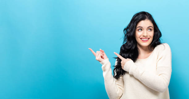 istock Young woman with a displaying hand gesture 973534160