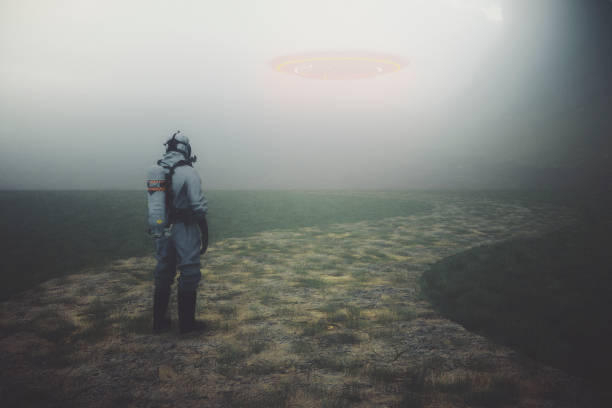 istock Man in hazmat suit watching UFO 973546776