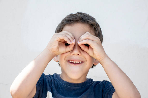 istock Smiling boy did fingers like binoculars 973557376