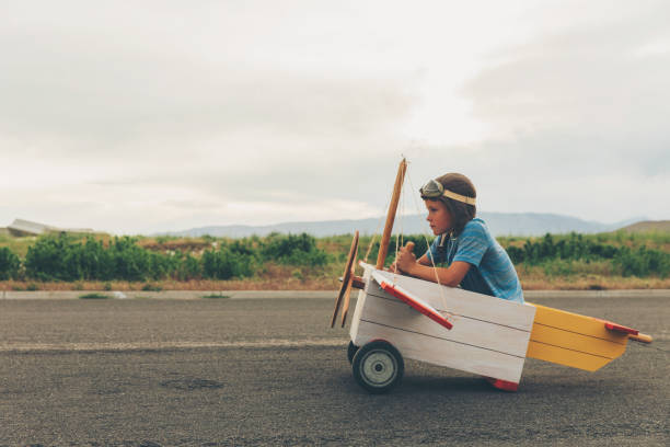 istock Young Boy Flies Toy Airplane 973564908