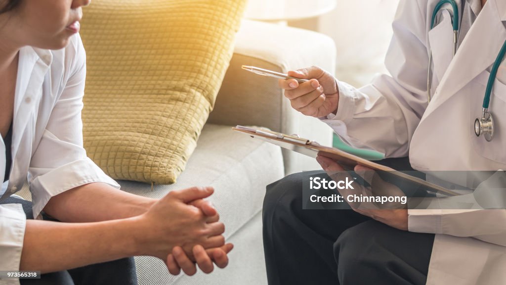 Gynecologist doctor or psychiatrist consulting and having diagnostic examination on woman patient's health in medical clinic or hospital exam room office Privacy Stock Photo