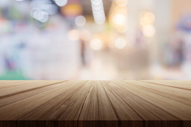 istock wood plank table top with warehouse store blur background 973565434
