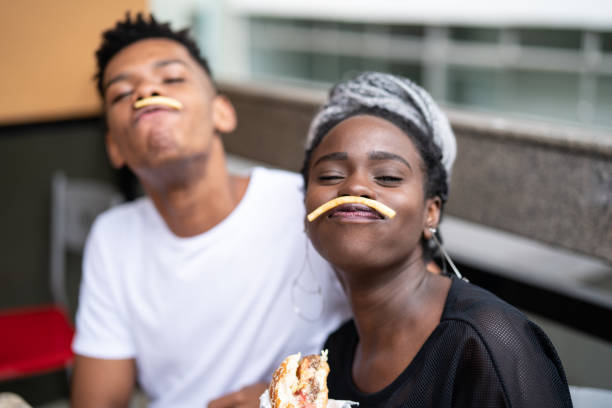 istock Group of young people having fun in a restaurant 973577192