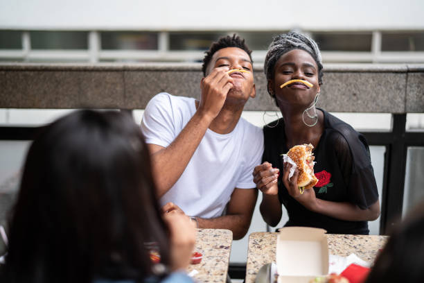 istock Group of young people having fun in a restaurant 973577288