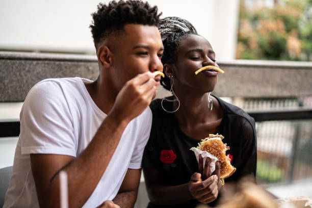 istock Group of young people having fun in a restaurant 973579392