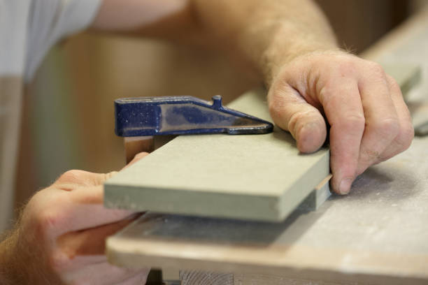 istock Carpenter Adding A Veneer To Wood 973579586