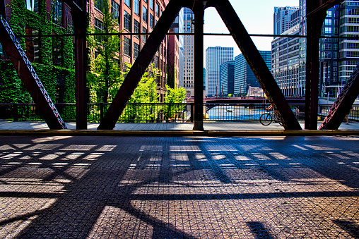 Bicyclist on Chicago's Lake Street underneath the shadows of the 