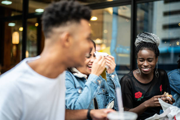 istock Group of young people having fun in a restaurant 973582696
