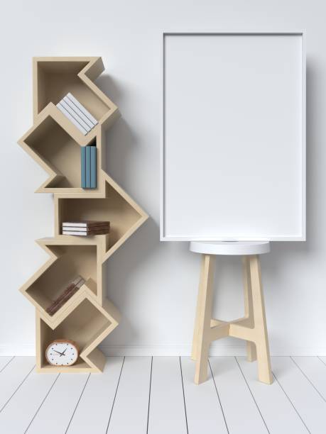 istock Bookshelf on the wall with books and white picture frame 973591072