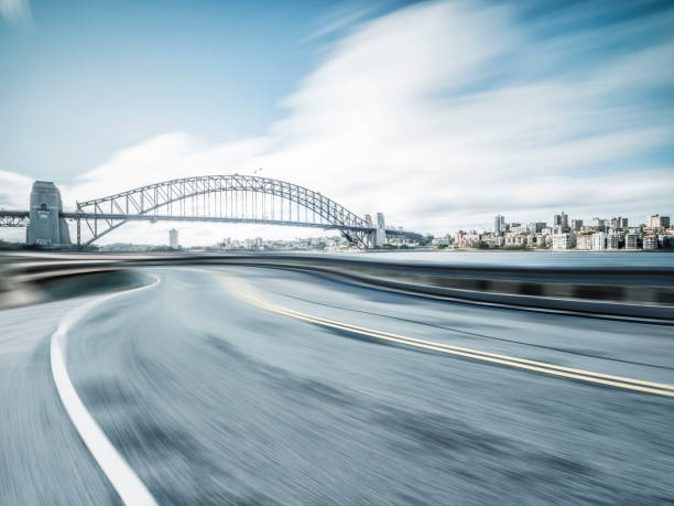 istock blurred motion road in Sydney with Sydney Harbor Bridge on background 973593712