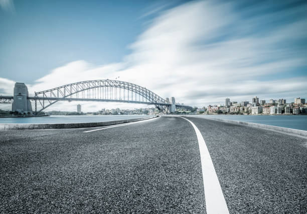 istock empty road by Sydney Harbor Bridge,Sydney 973593774