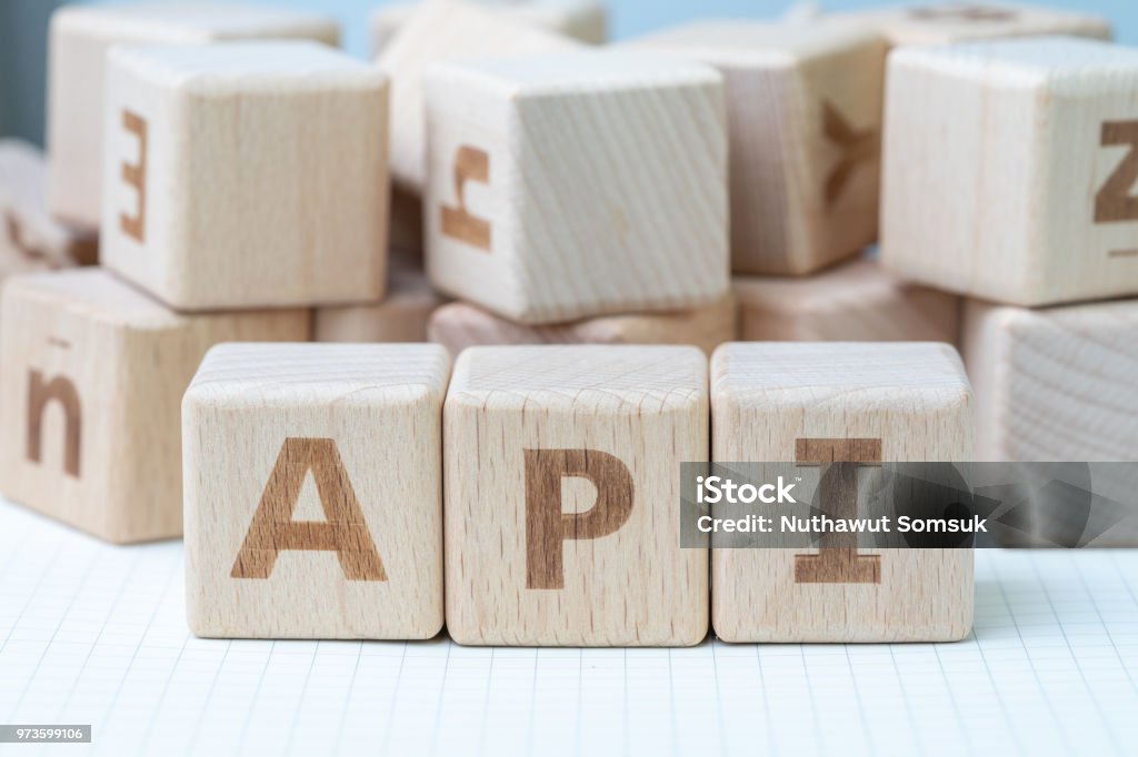 API, Application programming interface concept, cube wooden block with alphabet combine abbreviation API, technical term of middle thing to connect and sending data between computer and software - Royalty-free Bloco de Construção Foto de stock
