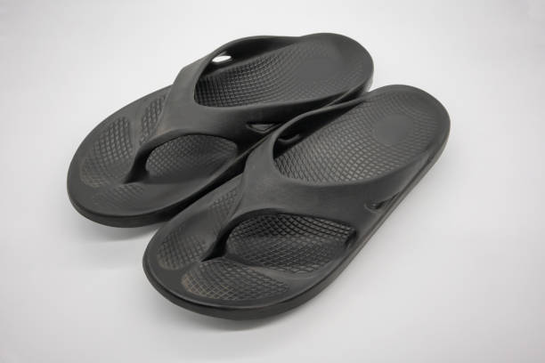 istock Black flipflops shoes isolated on white background 973609728