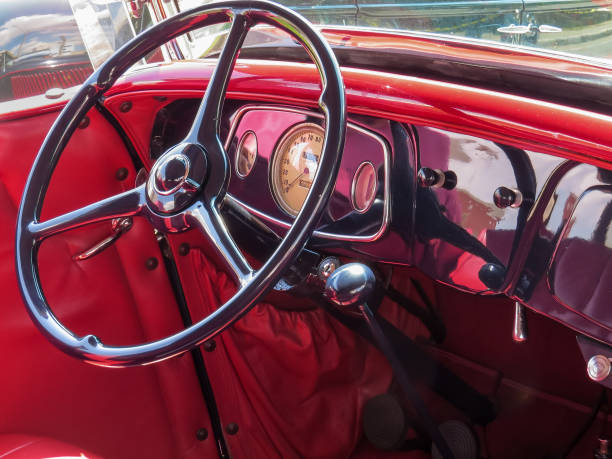 istock Red interior with classic car dashboard and steering wheel. 973609844