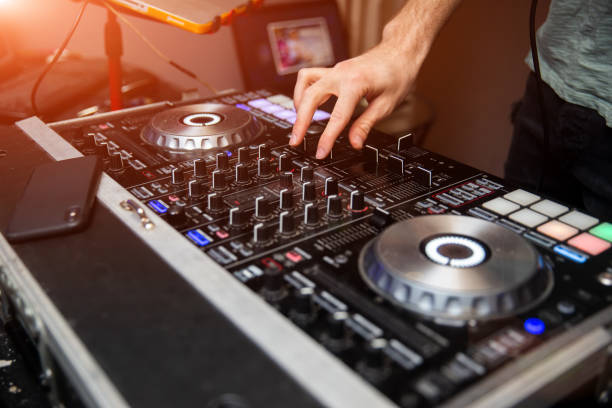 istock Young man working as dj with mixer. Shallow focus on hands. 973621638