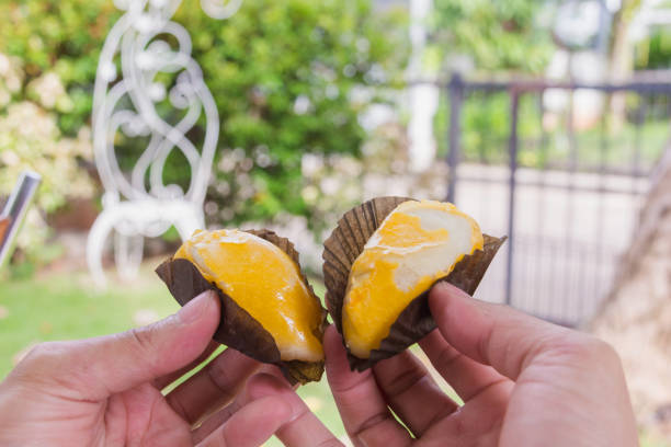 istock hand holding Durian Cake filling 973634056