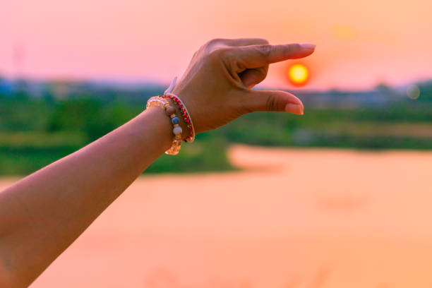 istock hands catch sun at sunset time concept. with copy space add text 973643108