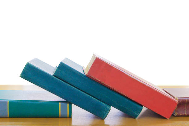 istock old book red - green. heap are interior library school on wooden table on white background with clipping path 973643734