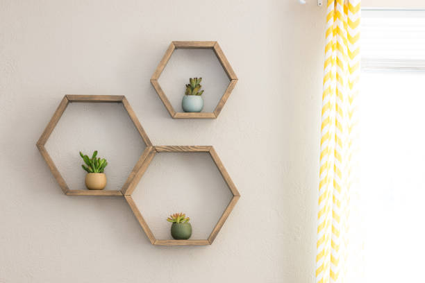Floating hexagon shelves with inside plants Three decorative wooden, floating, hexagon wall shelves, with decorative plants floating on water stock pictures, royalty-free photos & images