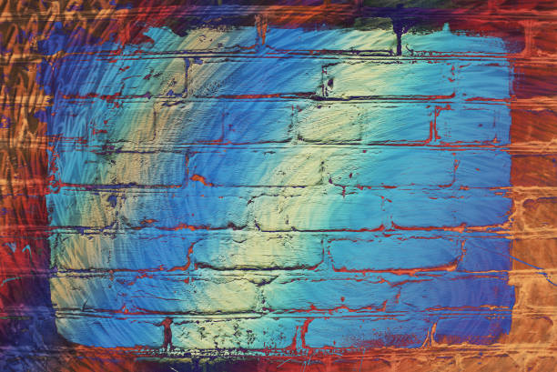 istock Hallucinogen neon surreal brick wall. Exotic fluorescent uneven wall with painted blue glowing center. Big rectangle for mock up in center close-up. Haunted imagination from drugs and alcohol. 973649386