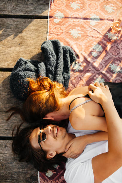 istock Couple lying on the pier at sunny summer day 973667038