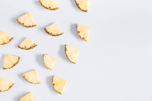 istock Pineapples on pastel blue background. Flat lay, top view 973671172