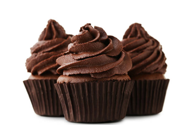 istock Chocolate cupcakes isolated on white background 973692530