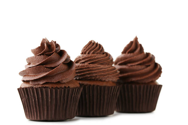 istock Chocolate cupcakes isolated on white background 973696622